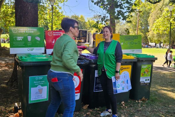 Roaming educator speaking to visitor about sustainability
